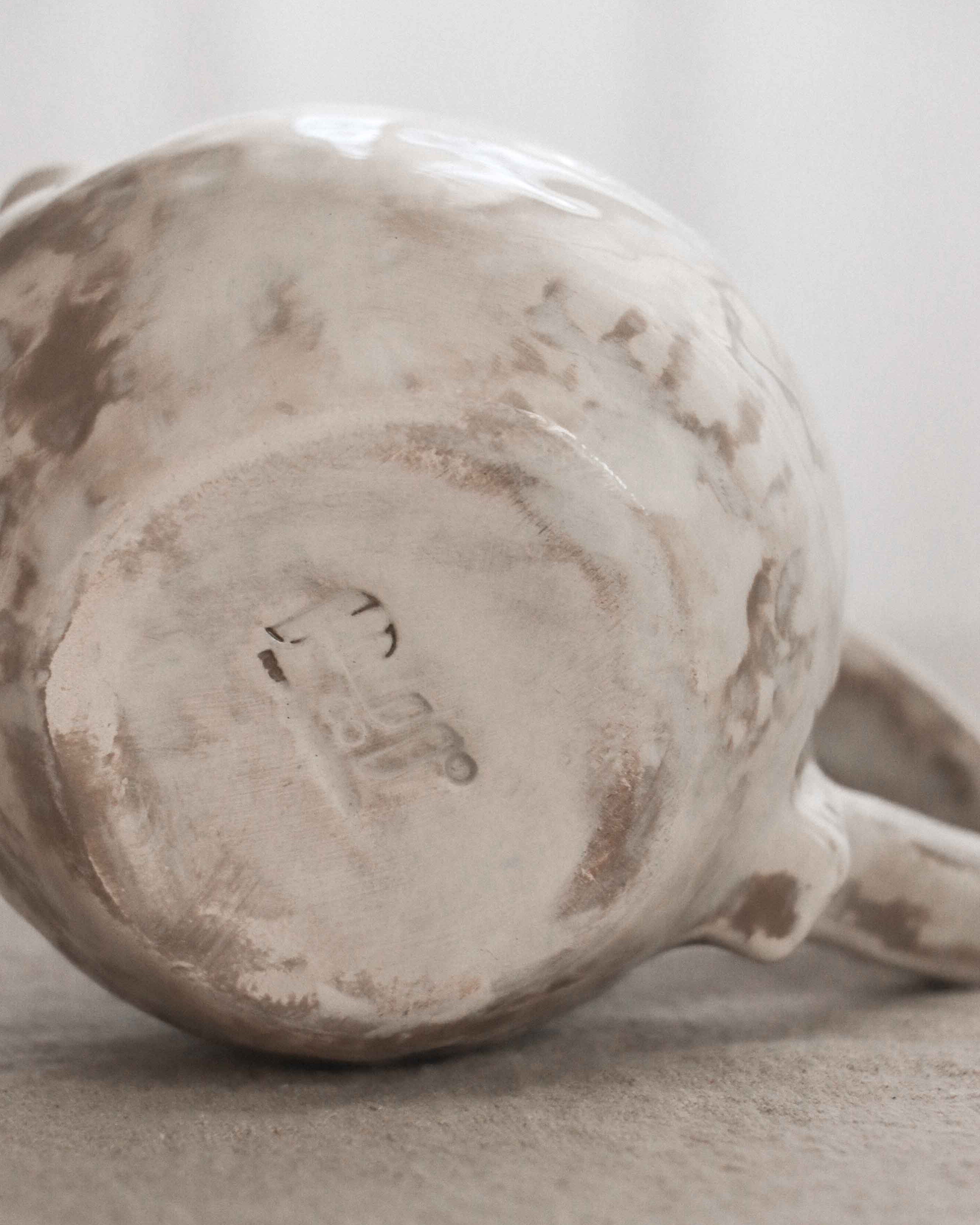 Close-up of a ceramic mug with a textured surface on a neutral background