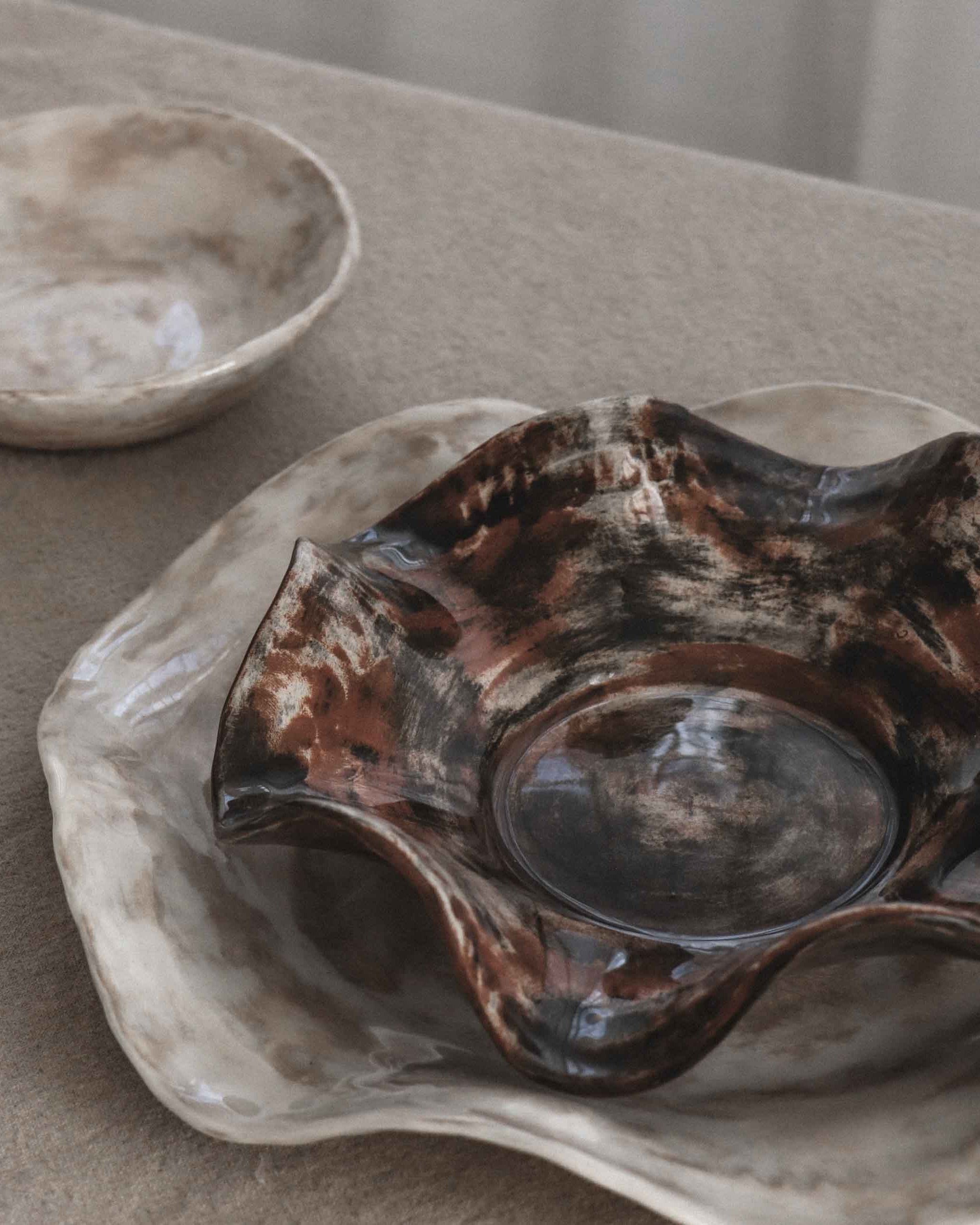 Two ceramic bowls on a textured surface